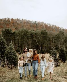 a family walking through the woods together