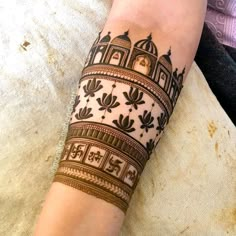 a woman's arm is decorated with henna tattoos