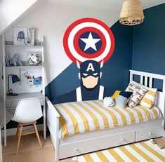 a bedroom with captain america wall decal on the wall and bed in the room