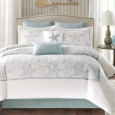 an image of a bed with starfishs on the comforter and pillow cases