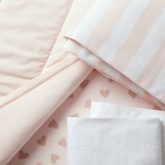 pink and white bedding with hearts on it