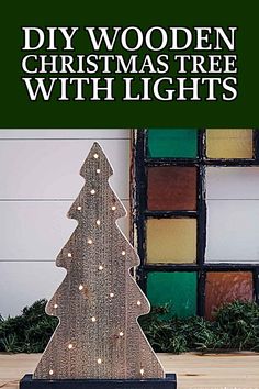 a wooden christmas tree with lights on it