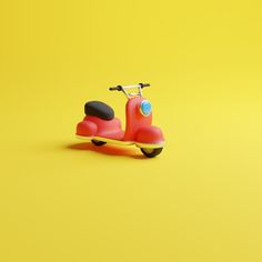 a red scooter sitting on top of a yellow background