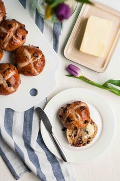 a white plate topped with muffins next to a blue and white towel