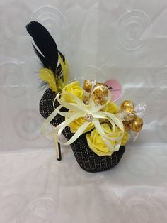 a small basket filled with chocolates and flowers on top of a white tablecloth