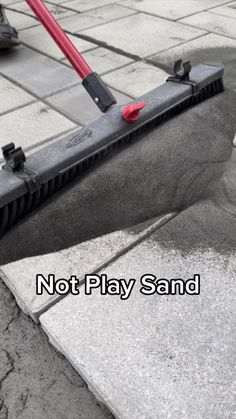 a mop laying on top of a sidewalk with the words not play sand