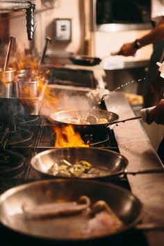 a person cooking food on top of a stove