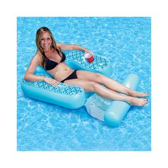 a woman sitting on an inflatable float at the edge of a swimming pool