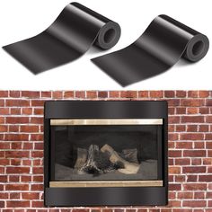 two pieces of black plastic sitting on top of a brick wall next to a fireplace