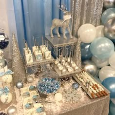 a table topped with lots of desserts and balloons