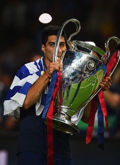 a man holding up a trophy in front of his face