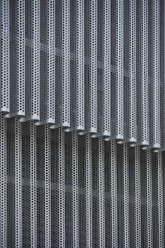 the side of a building with metal grates on it