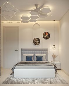 a modern bedroom with white walls and ceiling lights