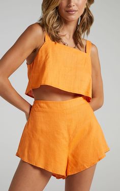 Set the summer vibes in our Save The Light Two Piece Set! This pretty ensemble features a crop top with thick adjustable straps and breezy mini shorts. It's a super versatile addition to your wardrobe that is perfect for day events or occasions hangs, and can be mix and matched. Slip it on for brunch, paired with sandals and a shoulder bag or for a casual day date with sneakers and a crossbody bag!Shop all Showpo.Product DetailsTopCrop topAdjustable strapsNo liningShortsElasticated waistFully li Set Outfit Two Pieces, Flare Shorts, Summer Two Piece Outfits, Orange Two Piece, Matching Sets Outfit, Summer Shorts Outfits, High Waist Shorts, Sleeveless Crop Top, Casual Sets