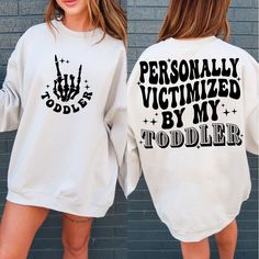 two women wearing matching sweatshirts that say, personalized by my todder and totally victim