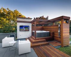 an outdoor hot tub on a deck in the backyard