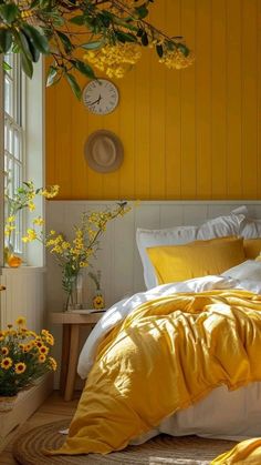 a bed with yellow sheets and pillows in a bedroom next to a clock on the wall