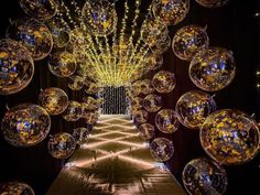 an elaborately decorated hallway with lots of shiny glass balls hanging from it's ceiling