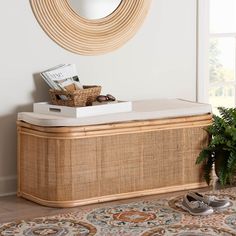 a basket sitting on top of a wooden chest next to a mirror and potted plant