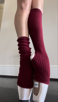 the legs and ankles of a woman wearing red socks with ruffles on them