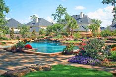 an outdoor swimming pool surrounded by lush green grass