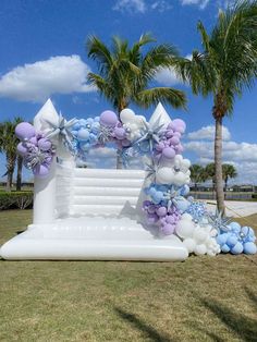 an inflatable arch decorated with balloons and bows