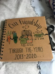 a notebook with an image of two people and the words, our friends through the years 2013 - 2020