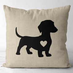 a pillow with a black dog silhouette on it