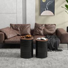 a living room with two leather couches and a coffee table in front of it