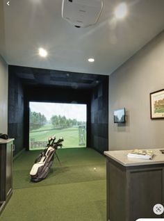 a golf simulator room with a green carpet