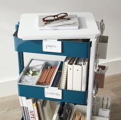 a blue and white book cart with some books on it