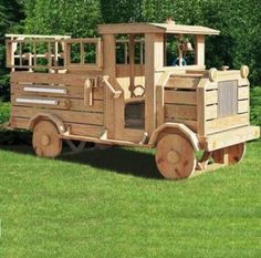 a wooden toy train sitting in the grass