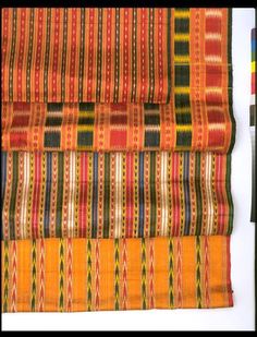 an orange and yellow striped cloth with different patterns on the edges, in various colors