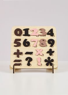 a wooden toy with numbers and symbols on it