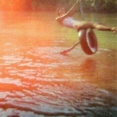 an image of a person in the water with a frisbee on his feet