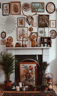 a fire place with many pictures on the wall