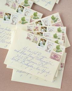 several envelopes with stamps on them are laying next to each other and the letters have been written in cursive writing