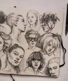 a drawing of some people with glasses on top of a book next to a pen