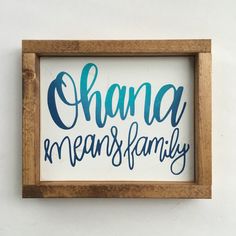 a wooden frame with the words ohana means family written in blue ink on it