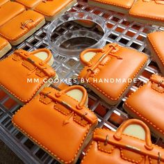 many orange purses sitting on top of each other