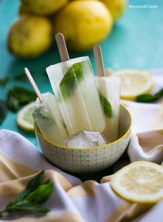 there are lemons and ice pops in the bowl