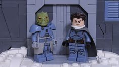 two lego star wars characters standing next to each other