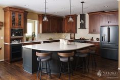 a large kitchen with wooden cabinets and an island in the middle, surrounded by bar stools