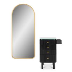 an oval mirror next to a black and gold cabinet