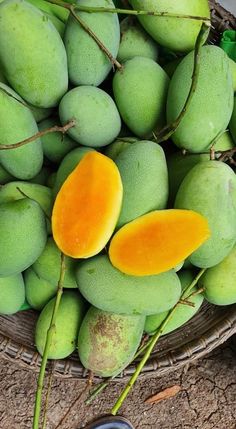 a basket filled with lots of green and yellow fruit