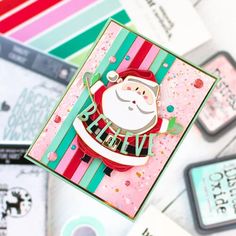 a close up of a christmas card on a table with other cards and stickers