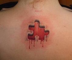 the back of a woman's shoulder with a piece of puzzle on it