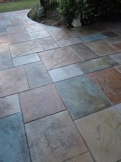 an outdoor patio with stone pavers in the middle