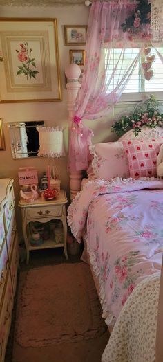 a bed room with a neatly made bed and pink comforter on it's side