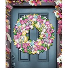 a blue door with a pink and yellow wreath on it